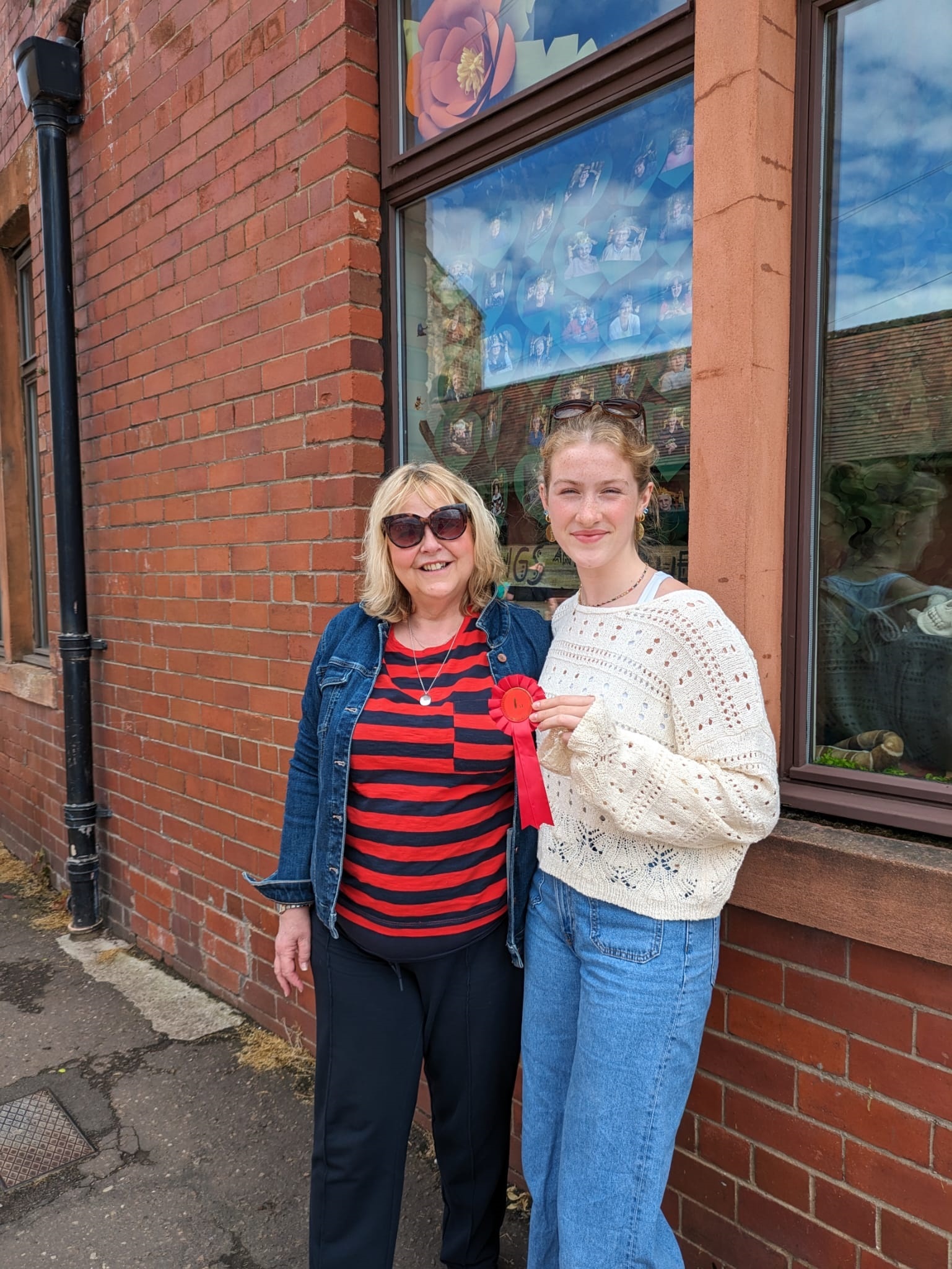 Natalie Campbell, from Knox Academy, and Christine Read, from Haddington and District Community Council, outside Haddington Day Centre which clinched first place in the window competition